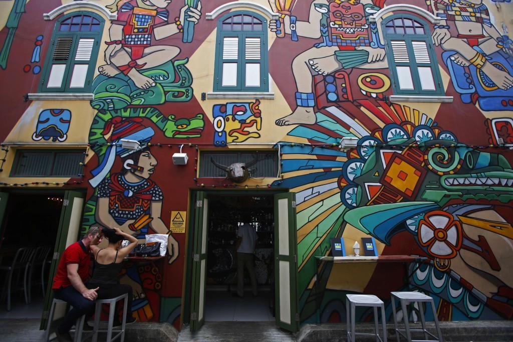 Patrons sit outside a pub at Arab Street in Singapore